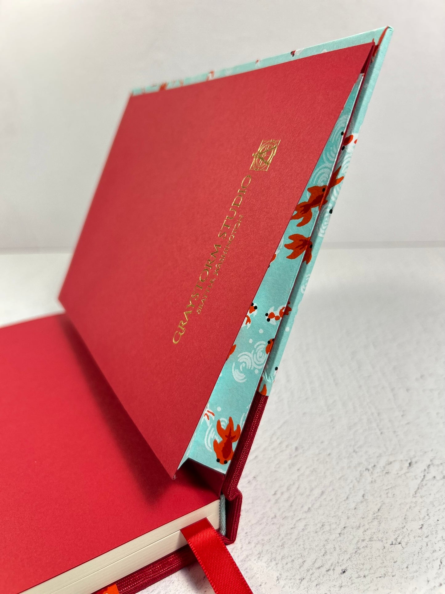 A5 Hardcover Notebook finished in Scarlet Red Japanese Bookcloth and Red/Orange Koi Fish on Aqua Chiyogami Paper