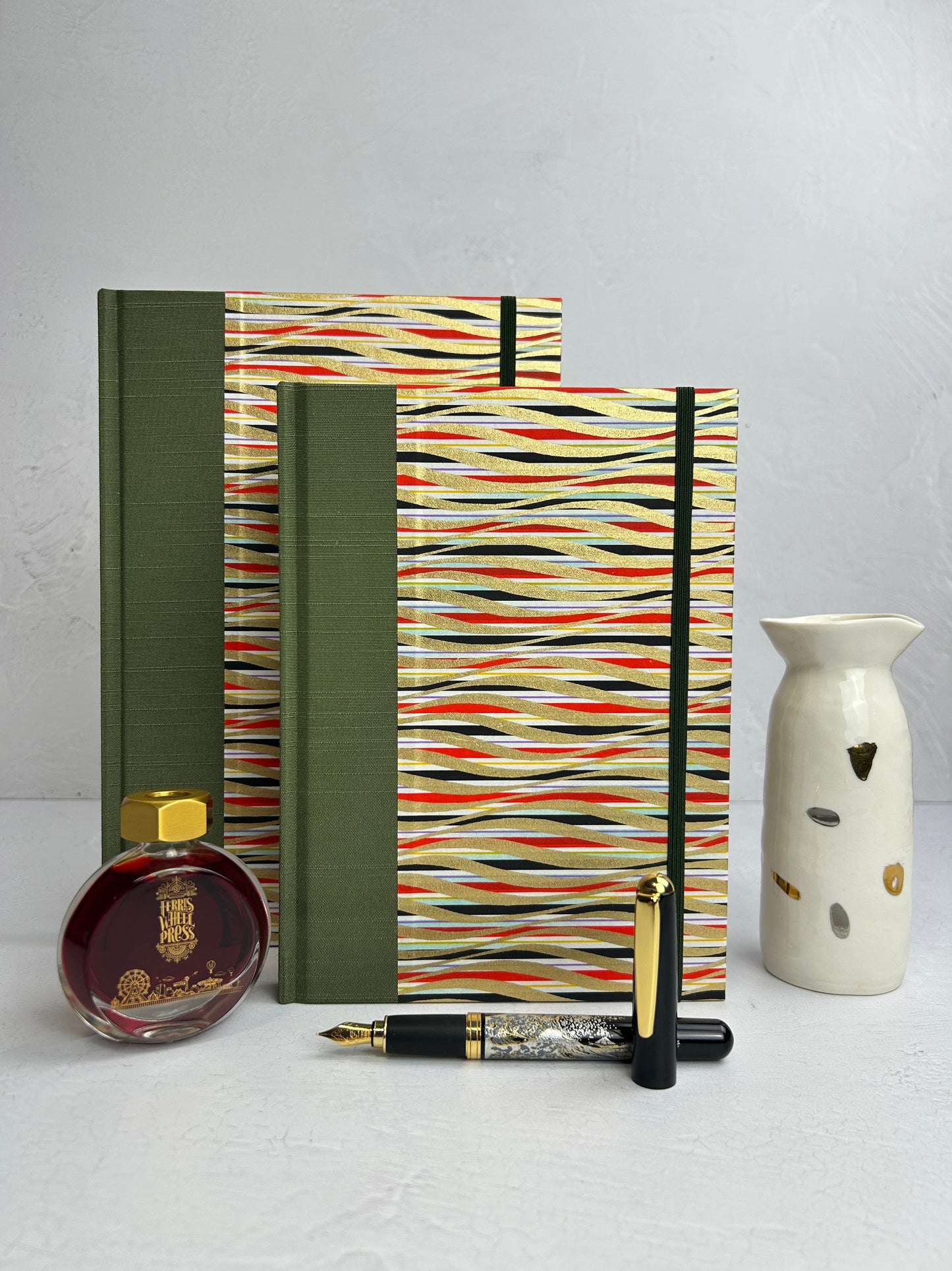 A5 160-page Hardcover Journal finished in olive green Japanese book cloth and gold, black and red geometric Chiyogami Paper