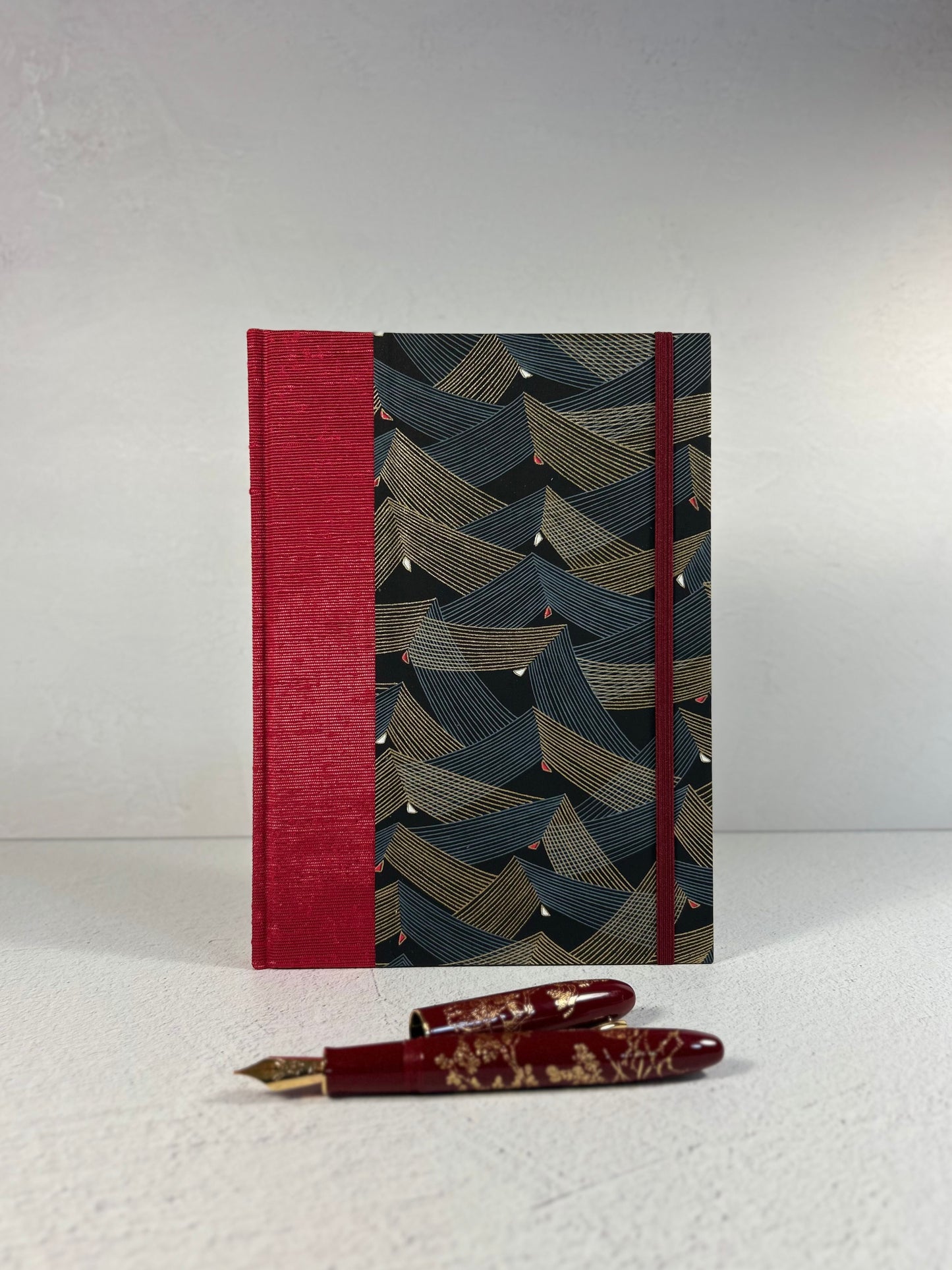 A5 160-page Hardcover Hardcover Notebook finished in Cardinal Red Japanese Bookcloth and Black and Gold Chiyogami Japanese Paper