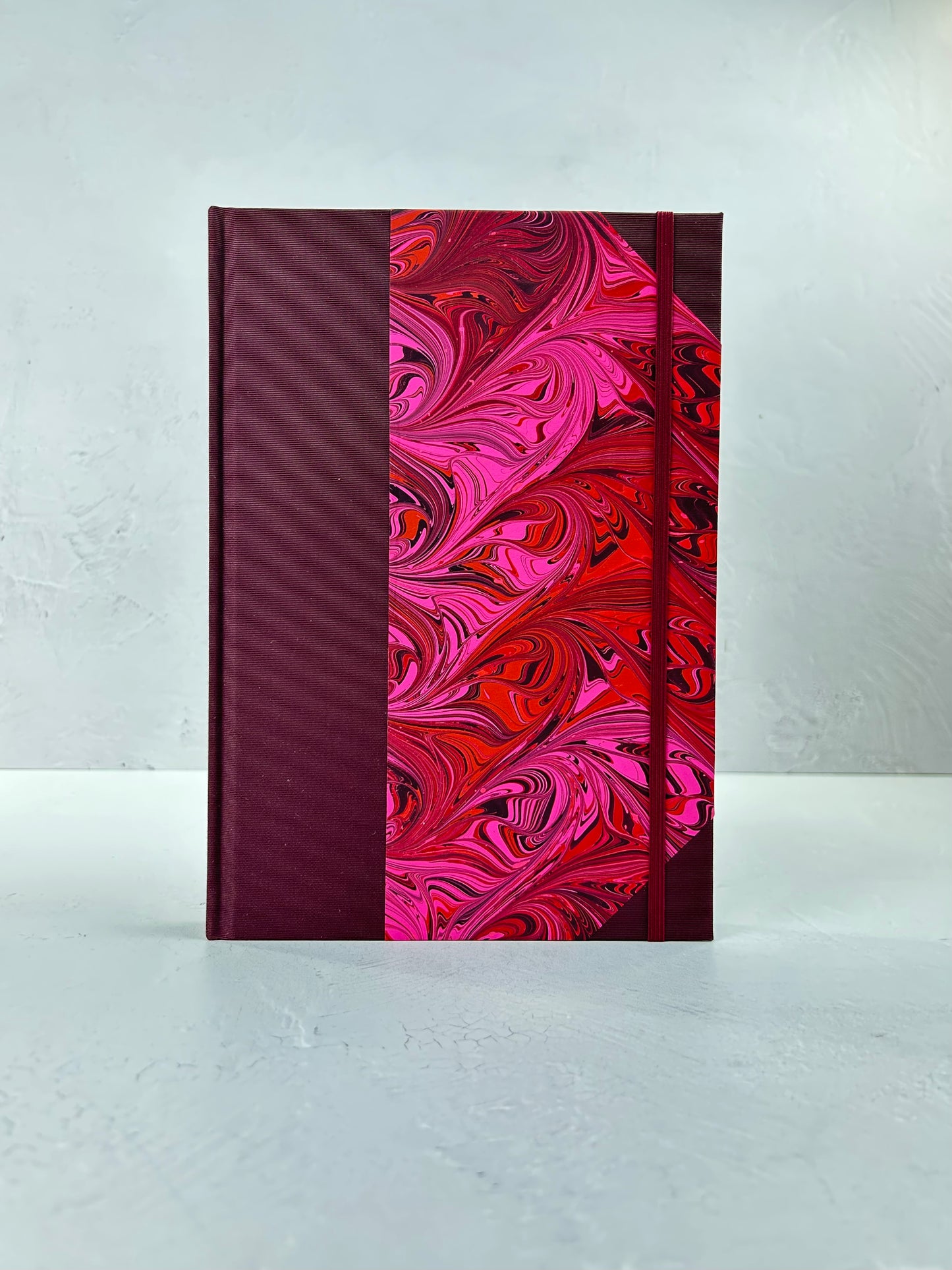 B5 192-page Hardcover Journal finished in Maroon Japanese book cloth and red/pink hand marbled paper by Daniel Gaál