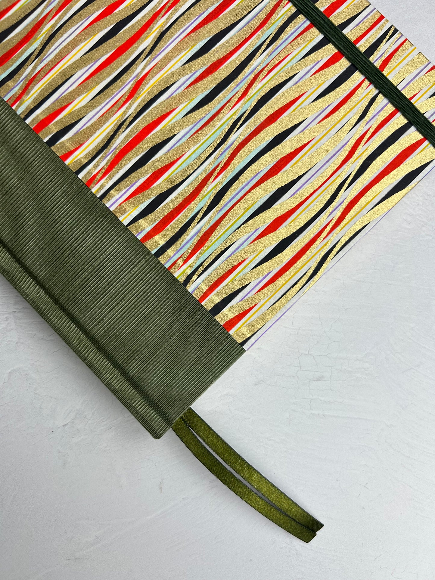 A5 160-page Hardcover Journal finished in olive green Japanese book cloth and gold, black and red geometric Chiyogami Paper