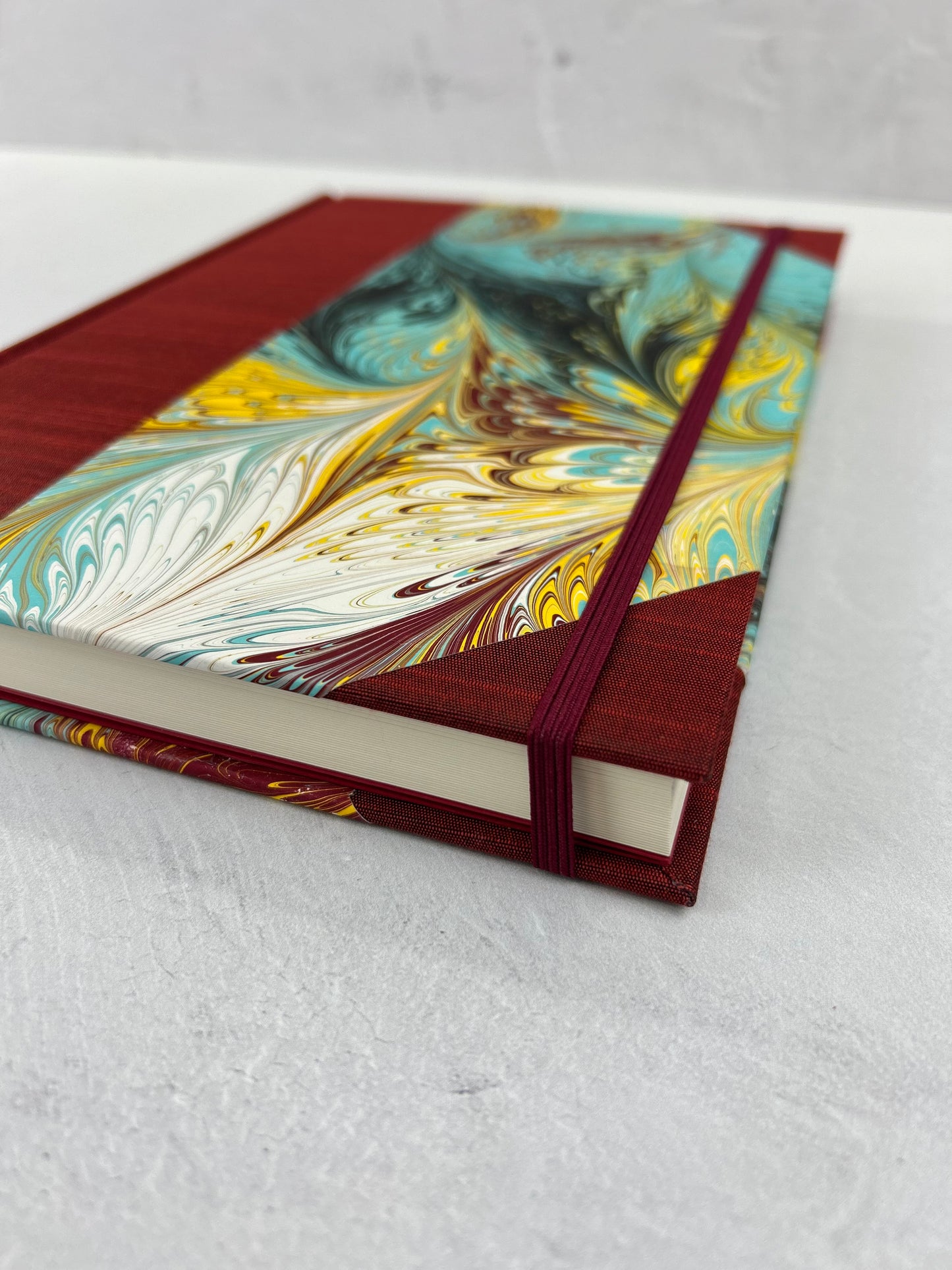 B5 192-page Hardcover Journal finished in Dark Red Japanese book cloth and hand marbled paper by Daniel Gaál