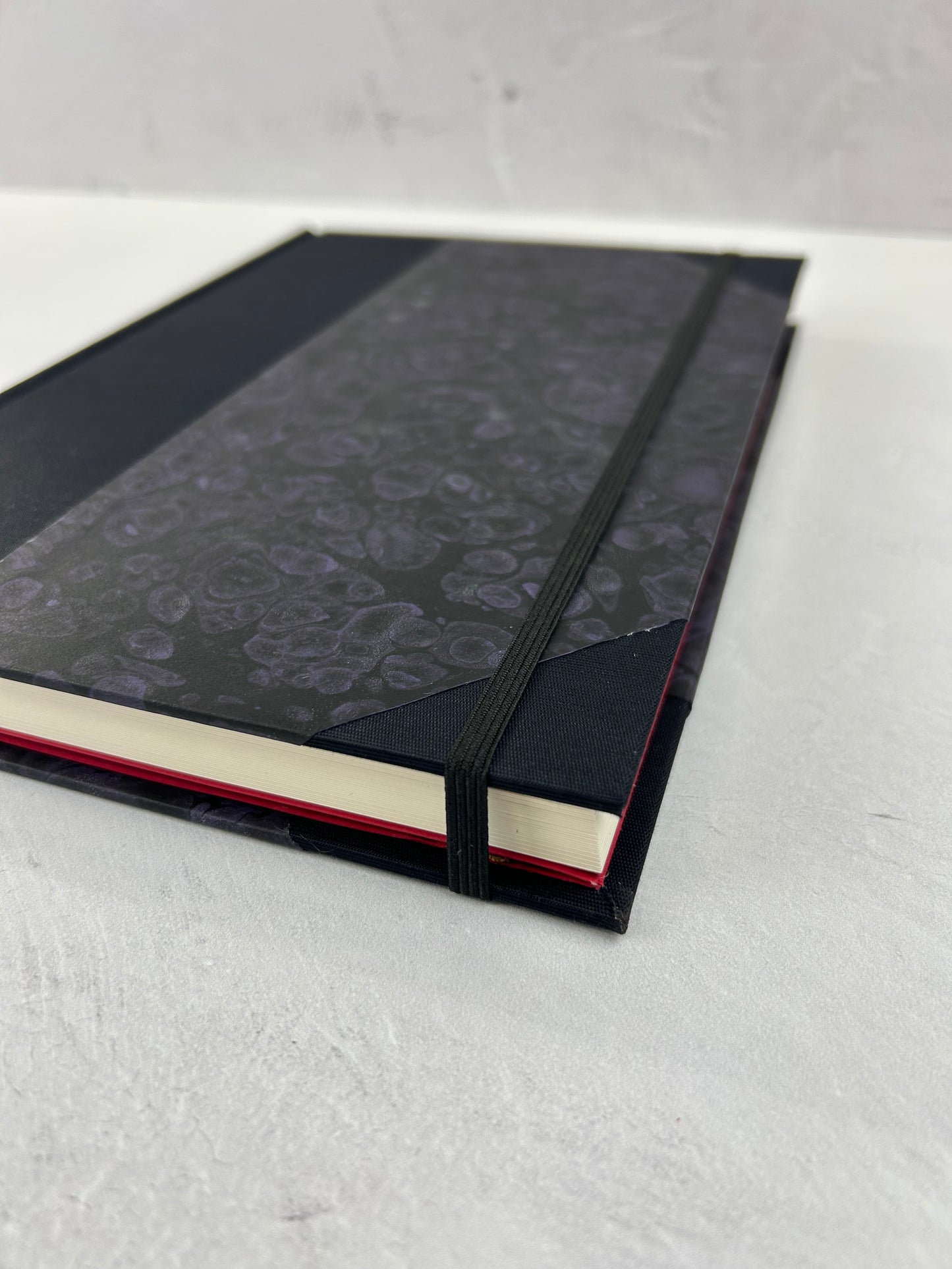 B5 192-page Hardcover Journal finished in Black Japanese book cloth and indigo hand marbled paper by Daniel Gaál
