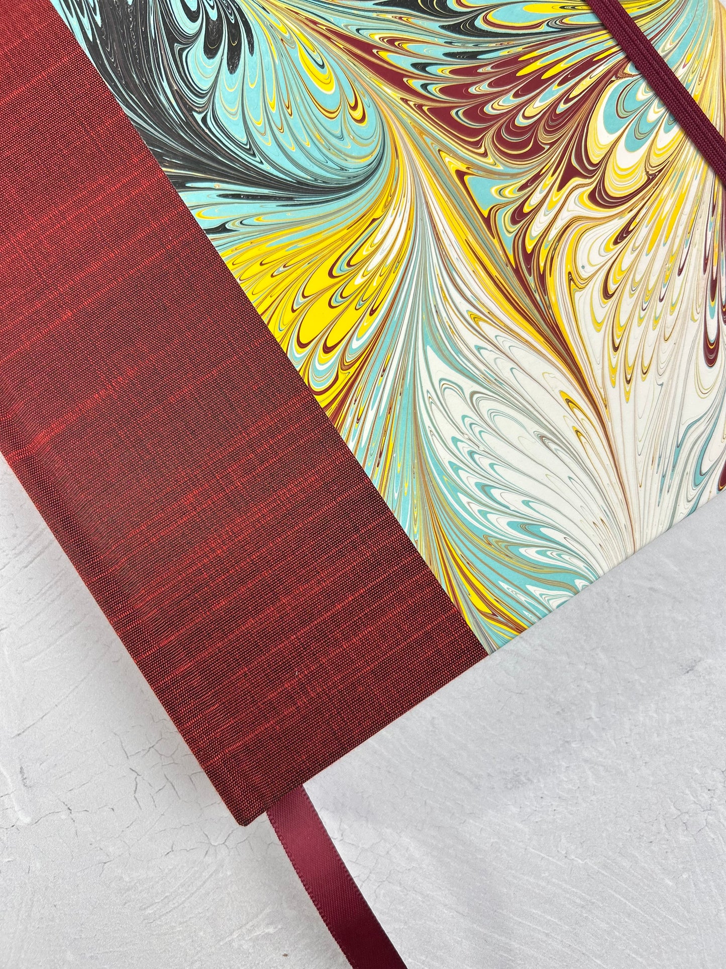 B5 192-page Hardcover Journal finished in Dark Red Japanese book cloth and hand marbled paper by Daniel Gaál