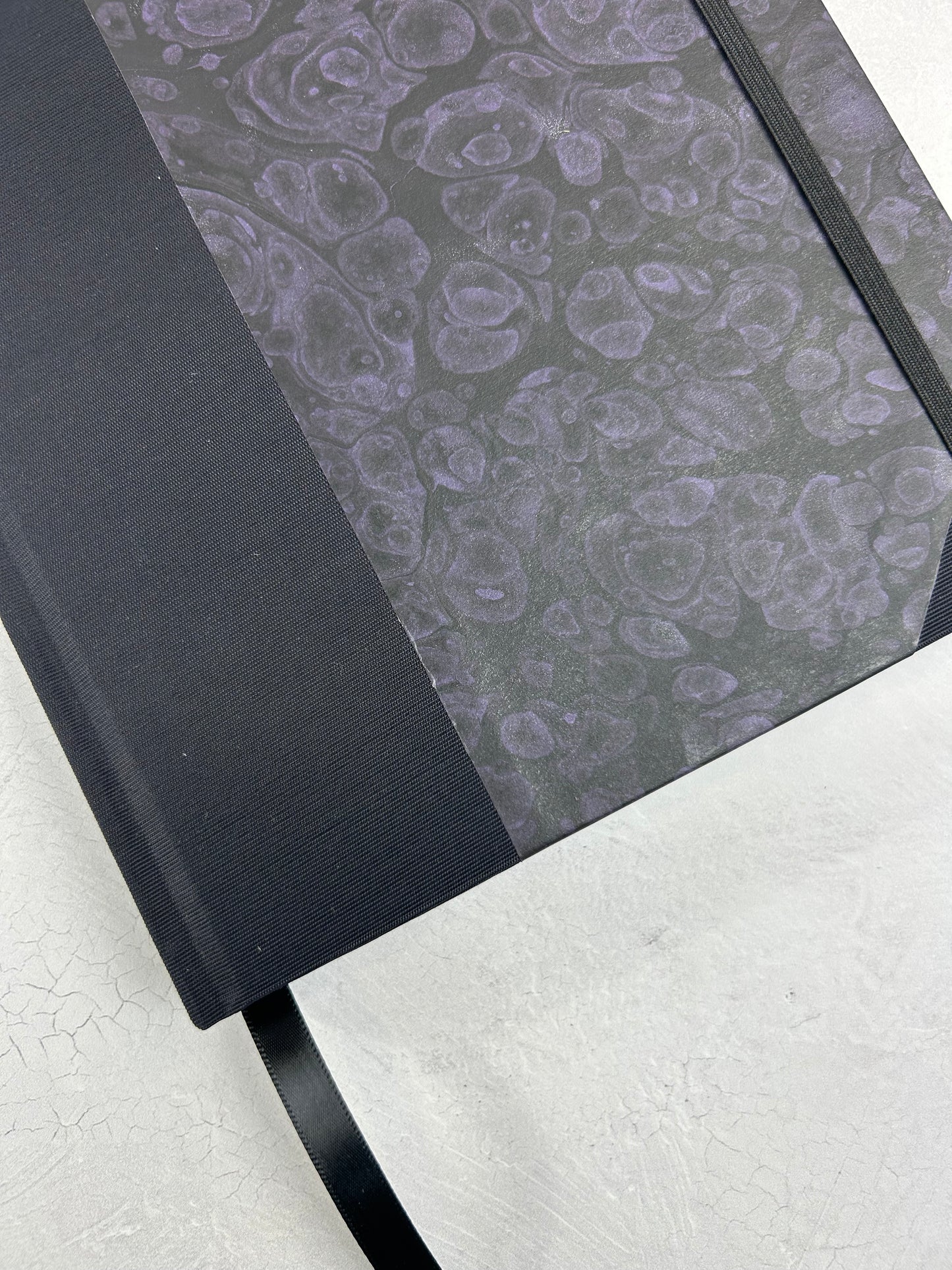 B5 192-page Hardcover Journal finished in Black Japanese book cloth and indigo hand marbled paper by Daniel Gaál