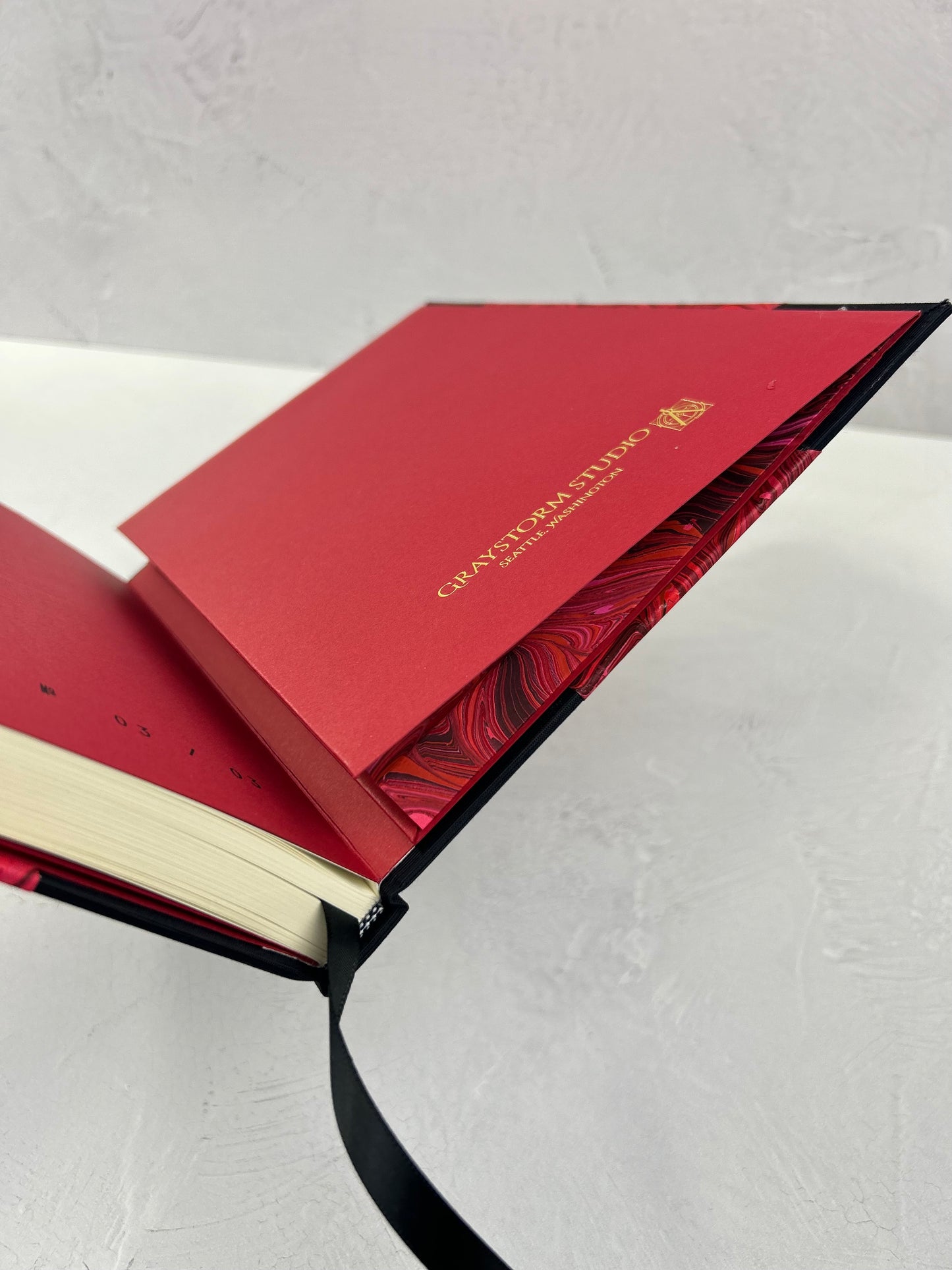 B5 192-page Hardcover Journal finished in Black Japanese book cloth and red hand marbled paper by Daniel Gaál