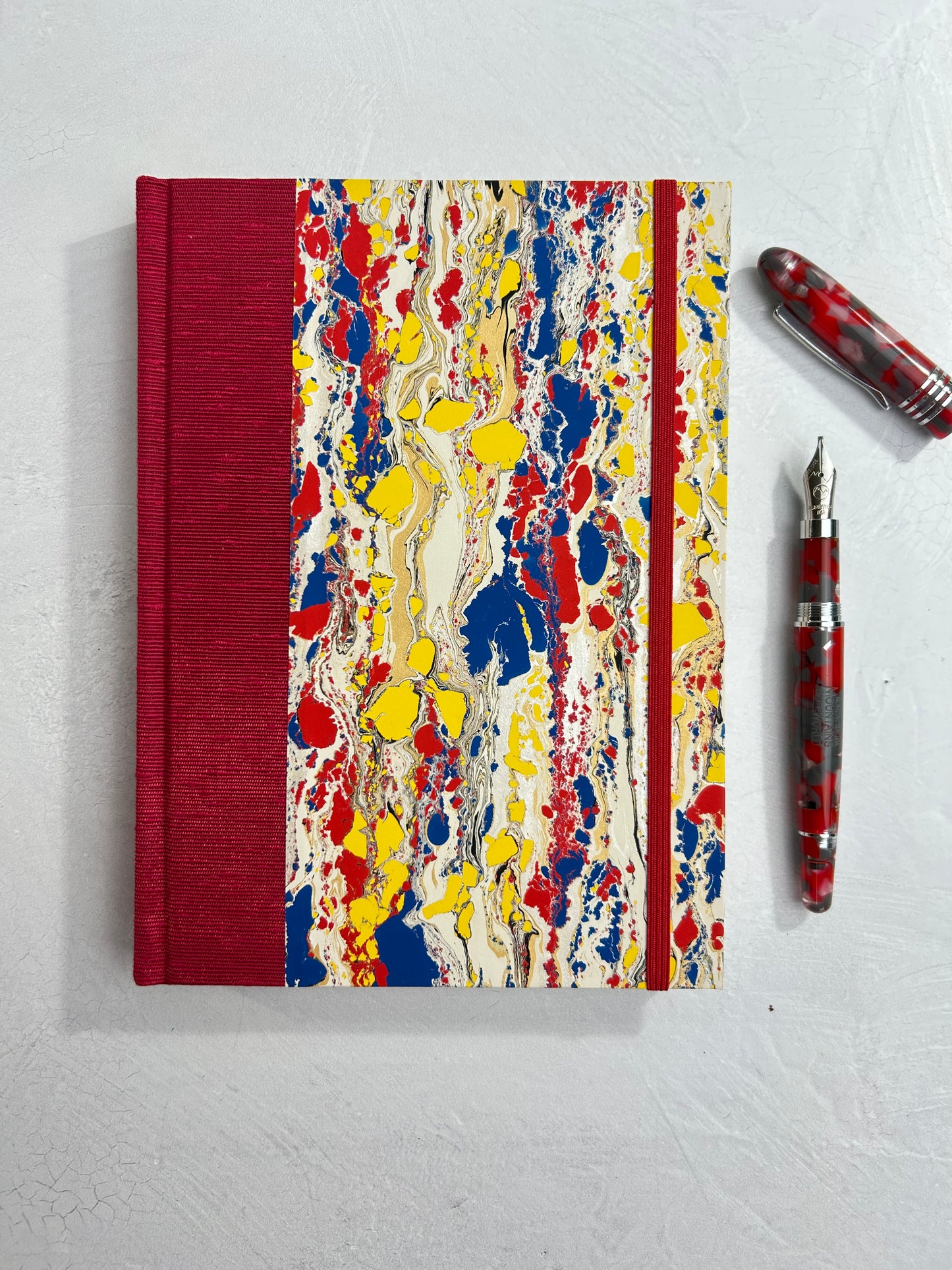 A5 160-page Hardcover Journal finished in Cardinal Red Japanese book cloth and Italian hand-marbled paper by Renato Crepaldi