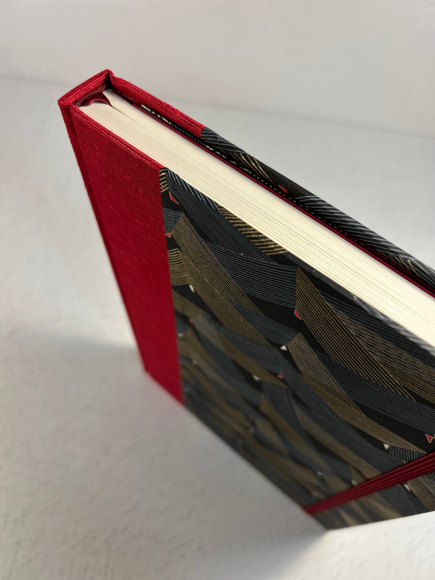 A5 160-page Hardcover Hardcover Notebook finished in Cardinal Red Japanese Bookcloth and Black and Gold Chiyogami Japanese Paper