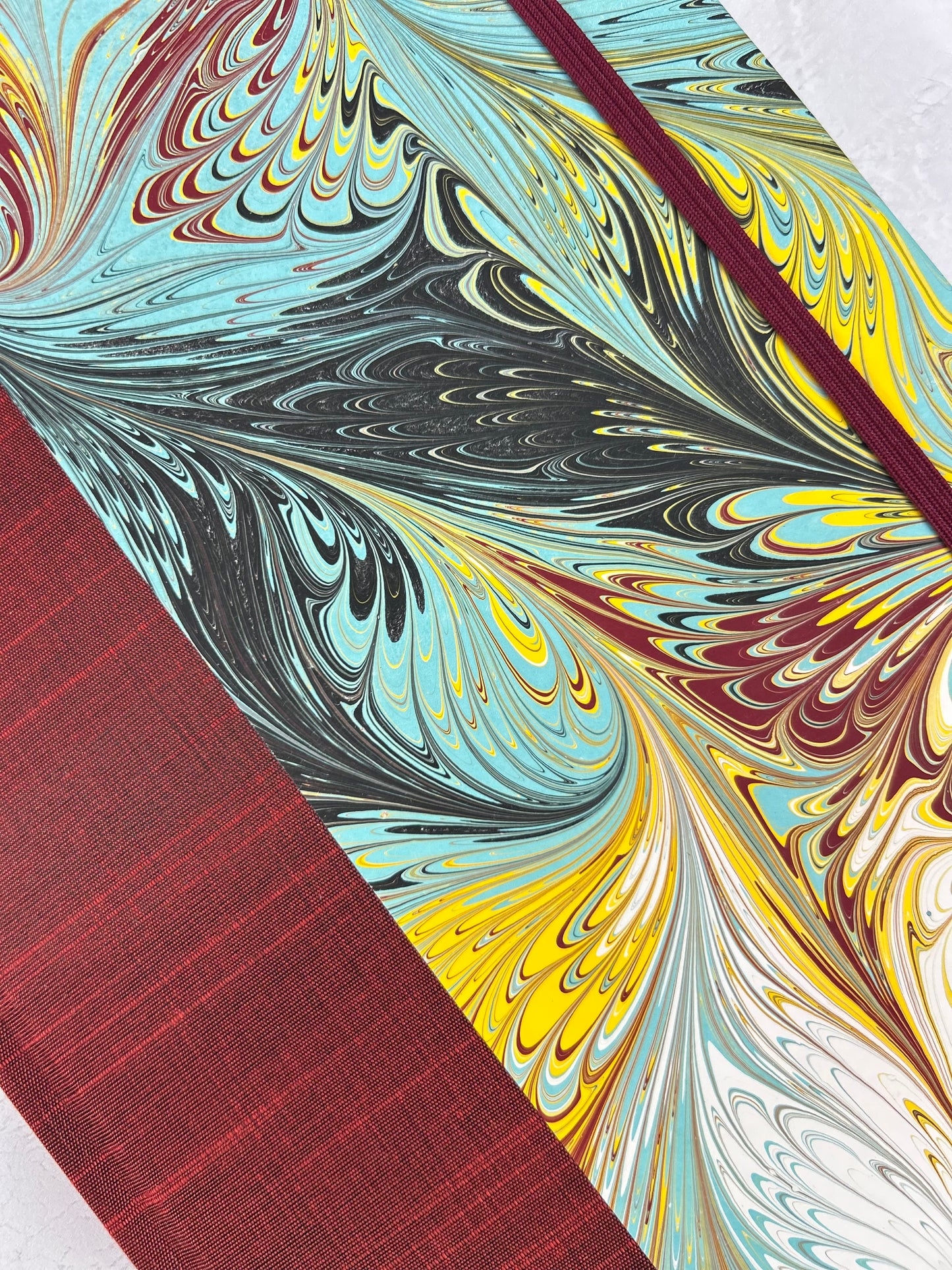 B5 192-page Hardcover Journal finished in Dark Red Japanese book cloth and hand marbled paper by Daniel Gaál