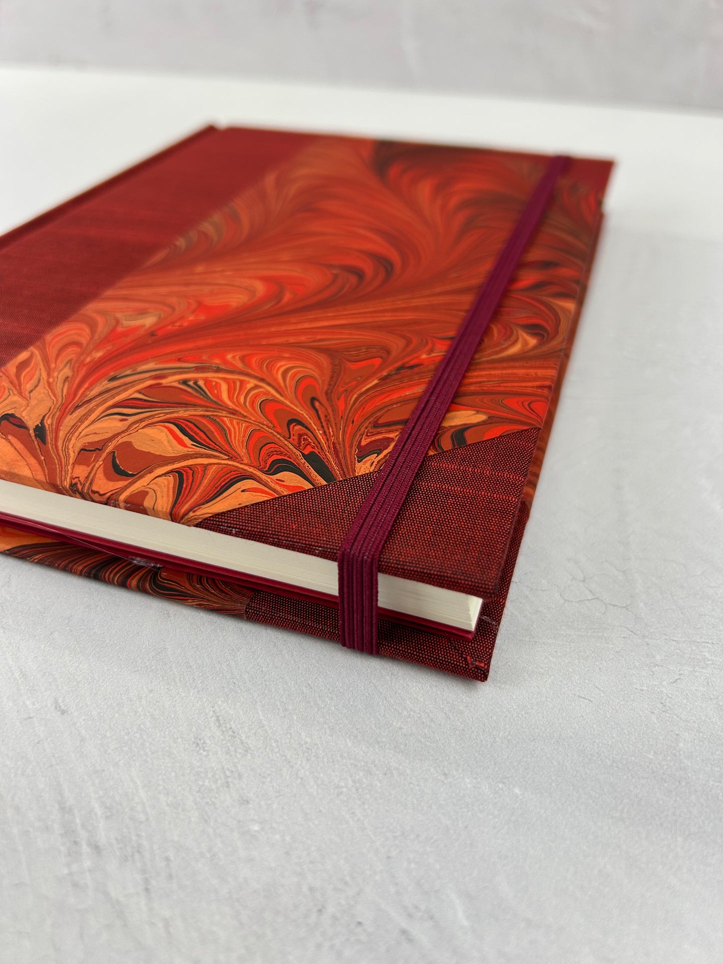 A5 160-page Hardcover Journal finished in Dark Red Japanese book cloth and hand marbled paper by Daniel Gaál