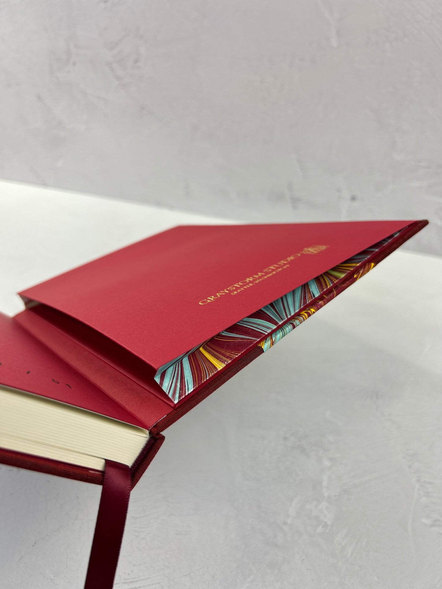 B5 192-page Hardcover Journal finished in Dark Red Japanese book cloth and hand marbled paper by Daniel Gaál