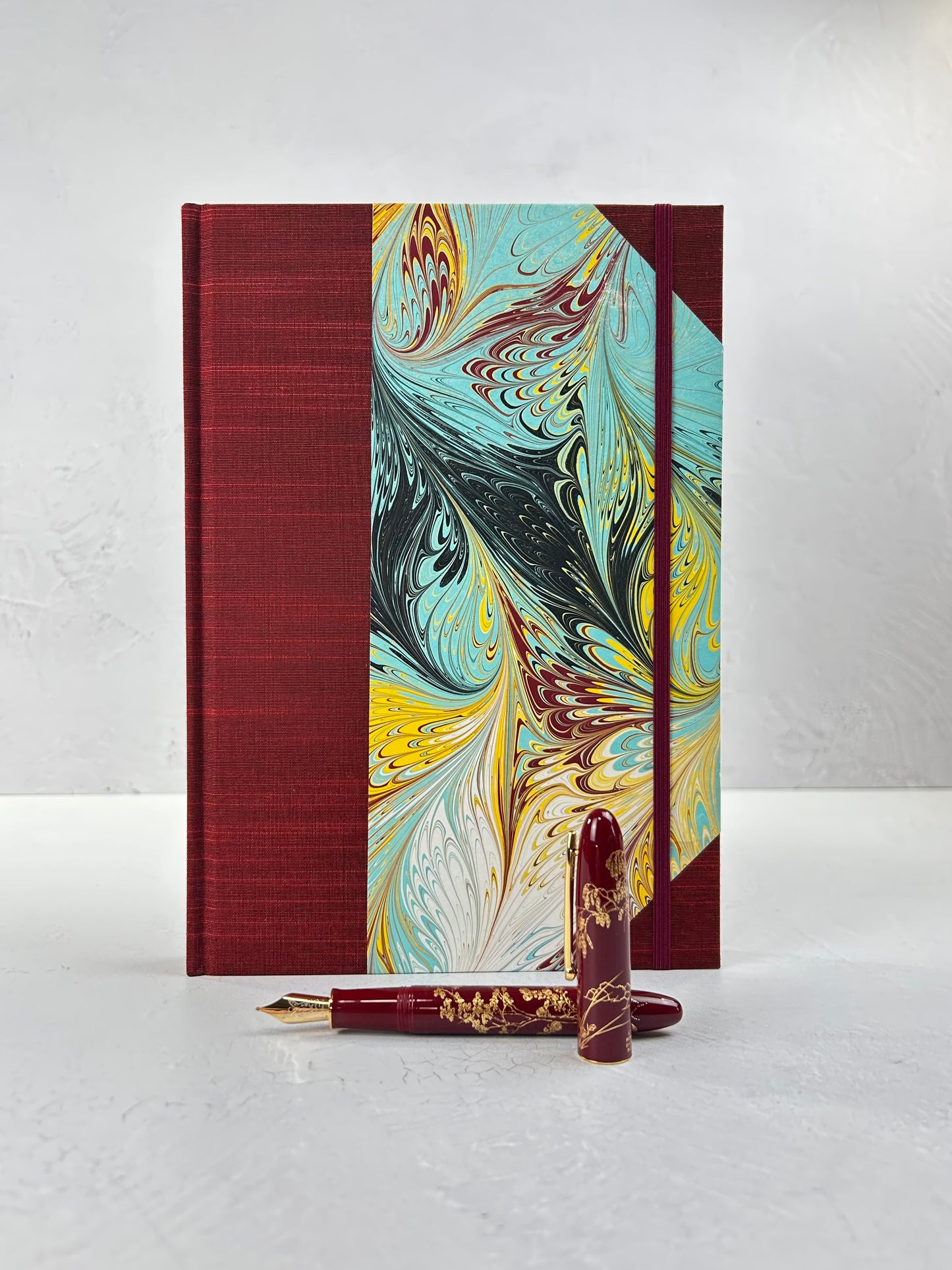 B5 192-page Hardcover Journal finished in Dark Red Japanese book cloth and hand marbled paper by Daniel Gaál