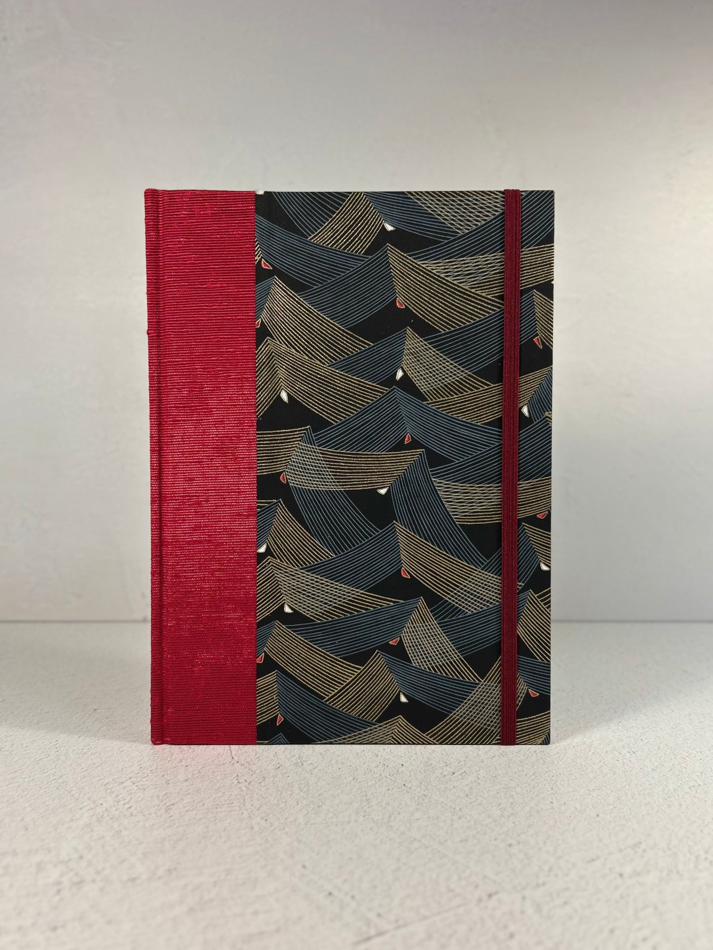 A5 160-page Hardcover Hardcover Notebook finished in Cardinal Red Japanese Bookcloth and Black and Gold Chiyogami Japanese Paper