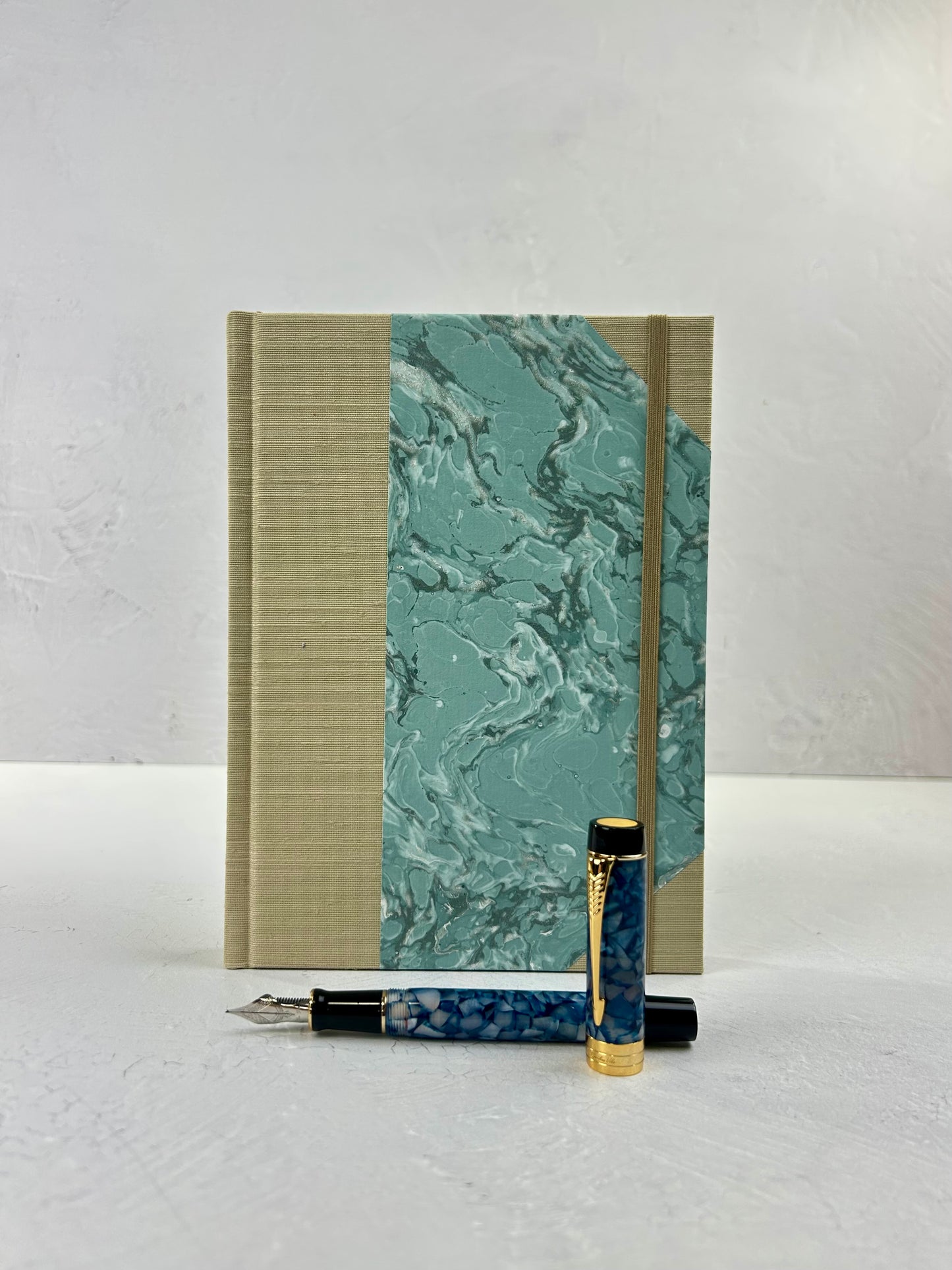 A5 160-page Hardcover Journal finished in Platinum Japanese book cloth and light blue French Marble Paper