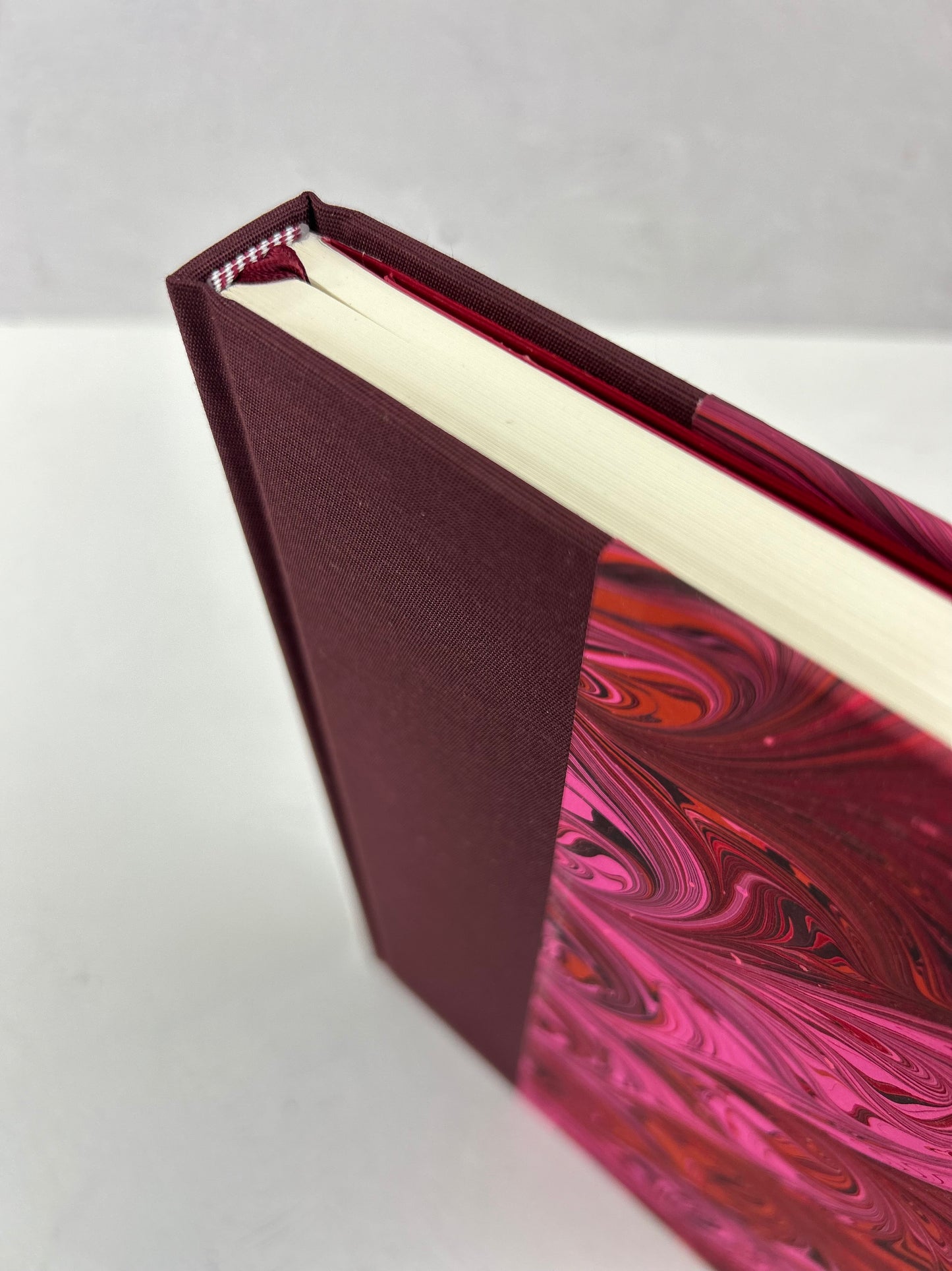 B5 192-page Hardcover Journal finished in Maroon Japanese book cloth and red/pink hand marbled paper by Daniel Gaál