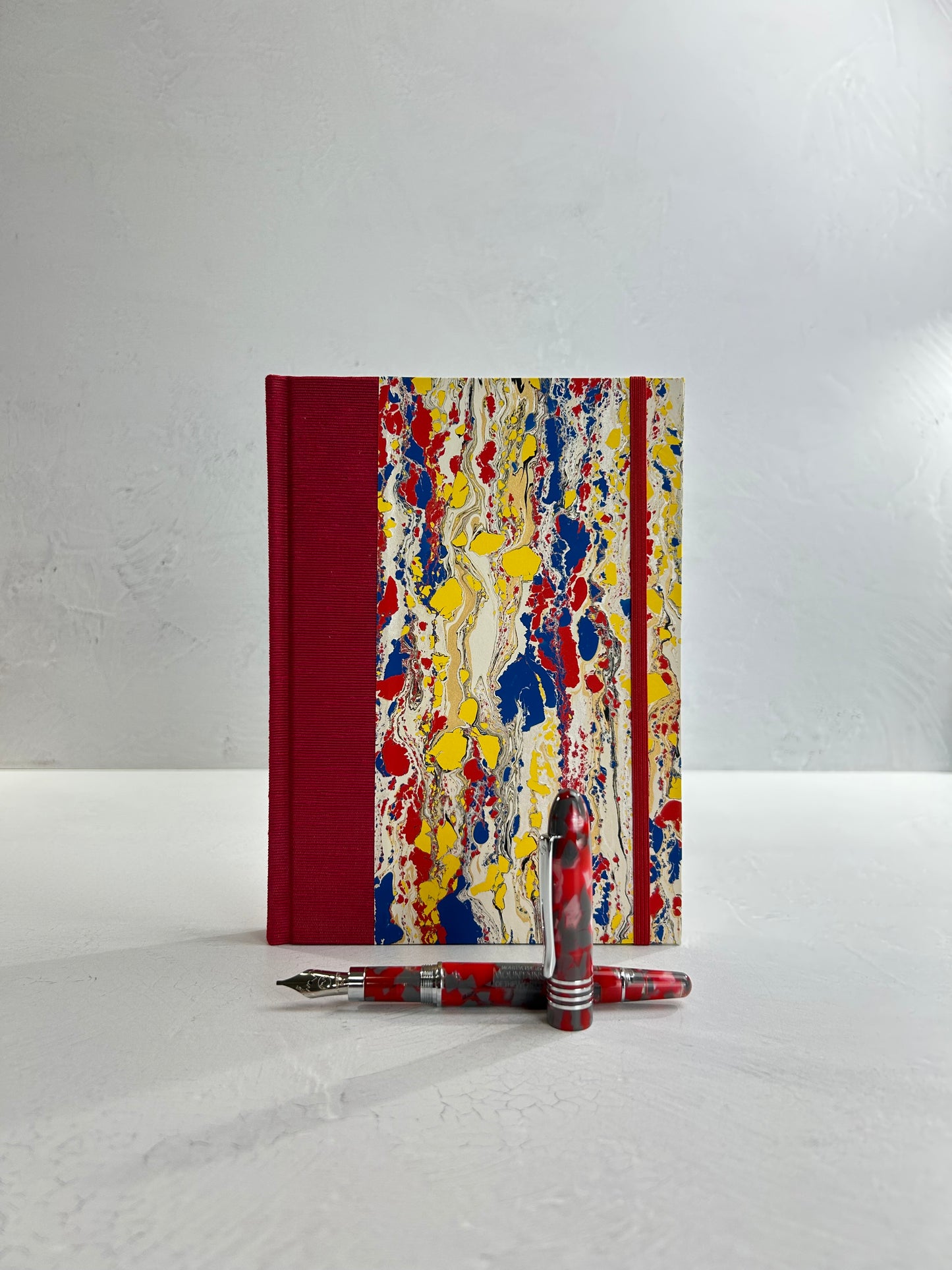 A5 160-page Hardcover Journal finished in Cardinal Red Japanese book cloth and Italian hand-marbled paper by Renato Crepaldi