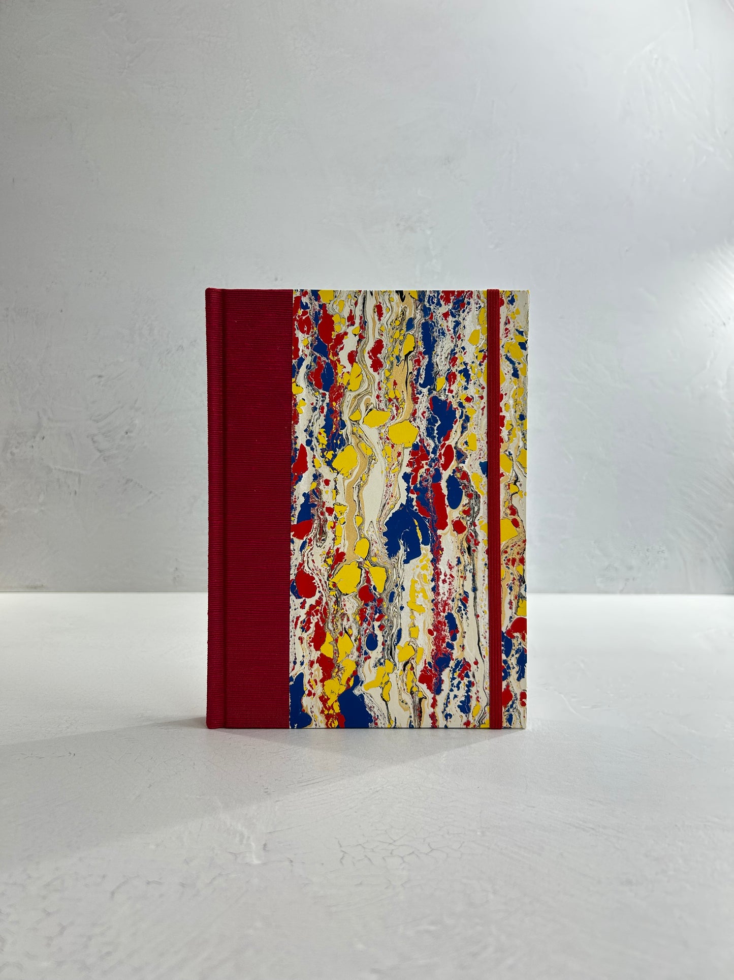 A5 160-page Hardcover Journal finished in Cardinal Red Japanese book cloth and Italian hand-marbled paper by Renato Crepaldi