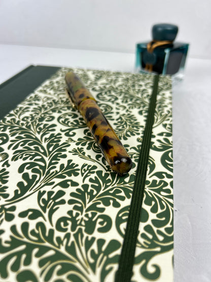A5 160-page Hardcover Journal finished in Green Vaux Leather and green and gold fern Italian Florentine print