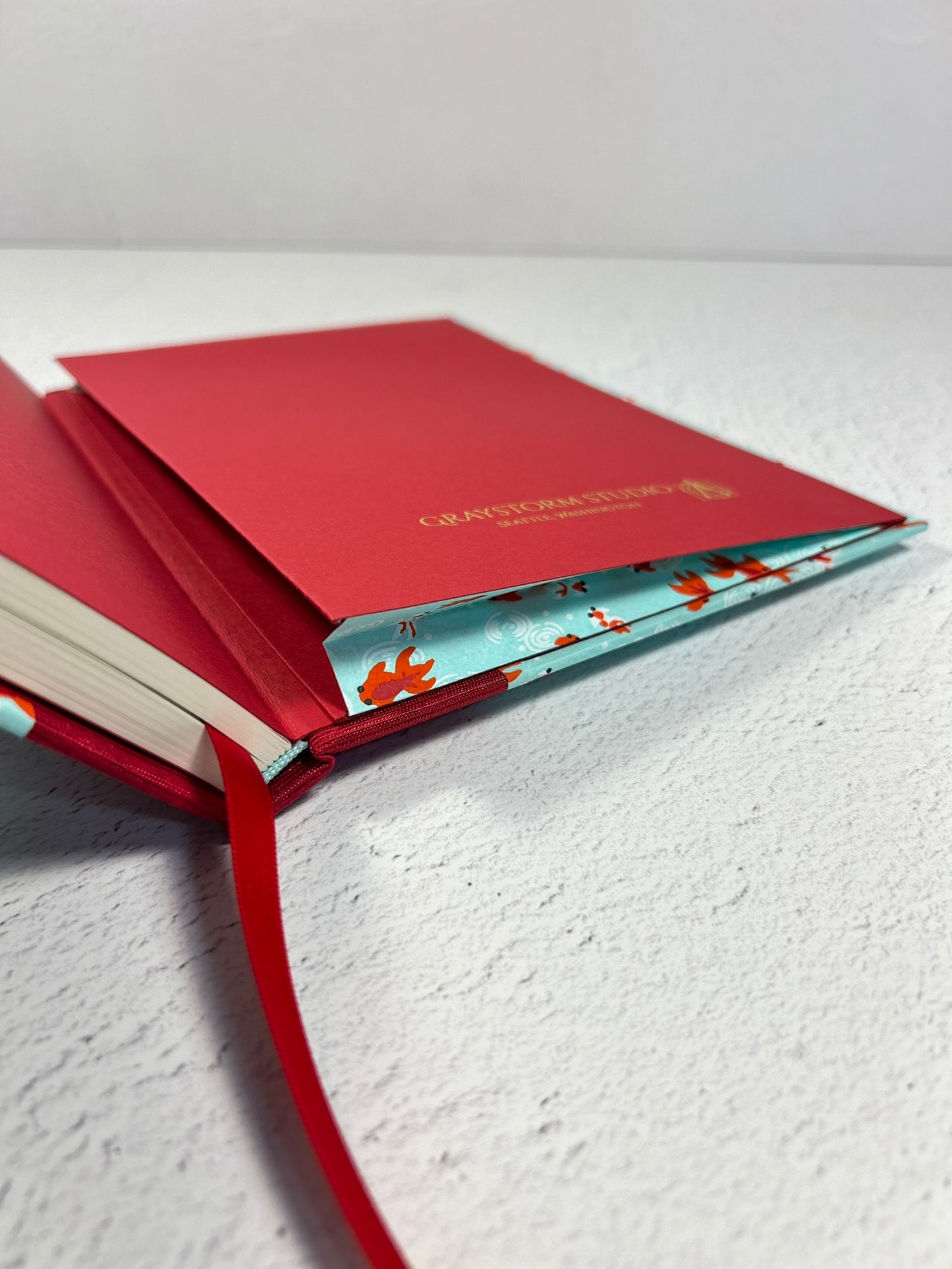 A5 Hardcover Notebook finished in Scarlet Red Japanese Bookcloth and Red/Orange Koi Fish on Aqua Chiyogami Paper