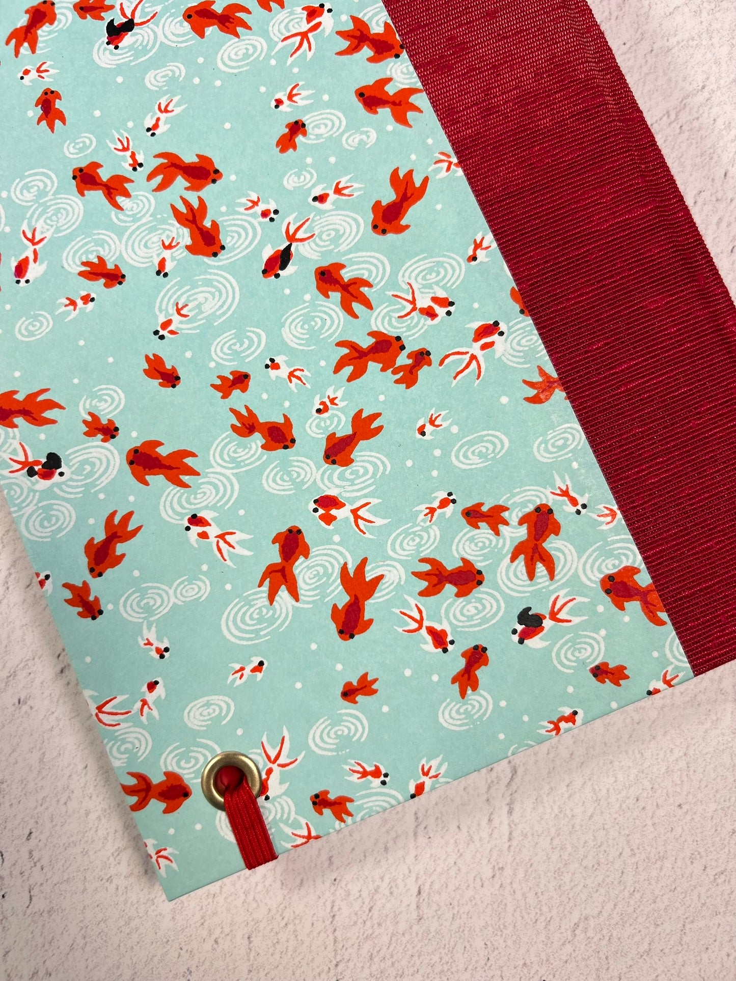 A5 Hardcover Notebook finished in Scarlet Red Japanese Bookcloth and Red/Orange Koi Fish on Aqua Chiyogami Paper