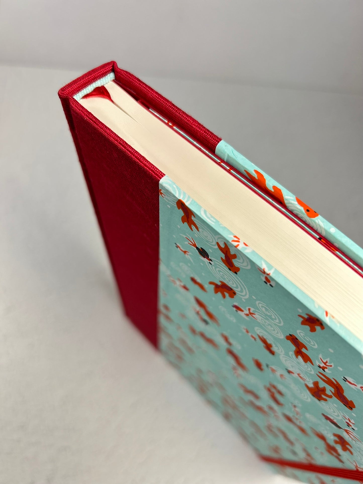 A5 Hardcover Notebook finished in Scarlet Red Japanese Bookcloth and Red/Orange Koi Fish on Aqua Chiyogami Paper