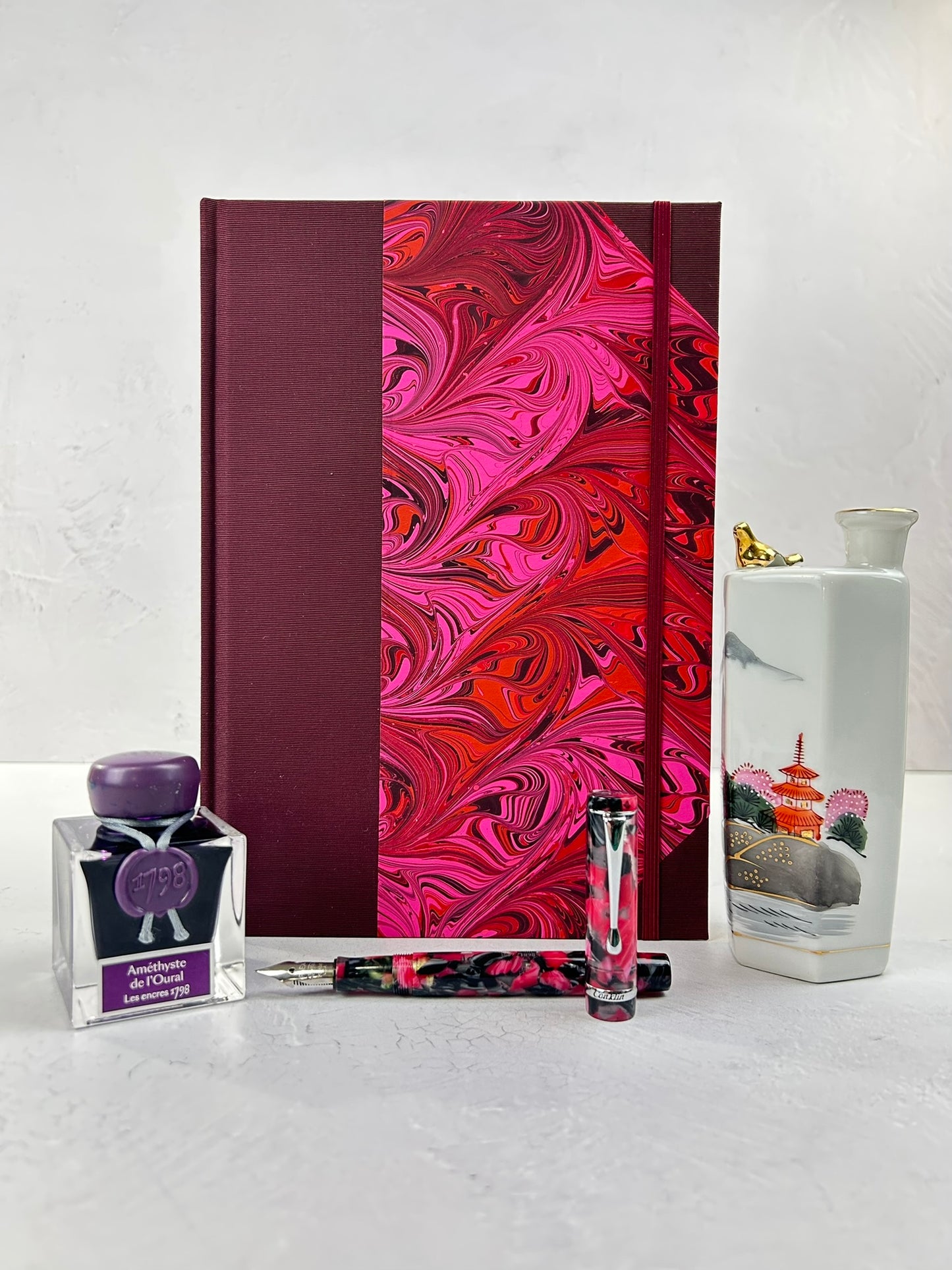 B5 192-page Hardcover Journal finished in Maroon Japanese book cloth and red/pink hand marbled paper by Daniel Gaál