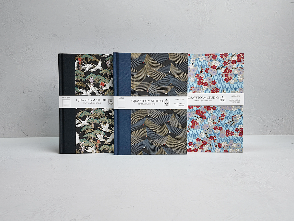 Three 128-Page Notebooks finished in White Cranes on Black, Golden Peaks on Black and Red Cherry Blossom Chiyogami Paper