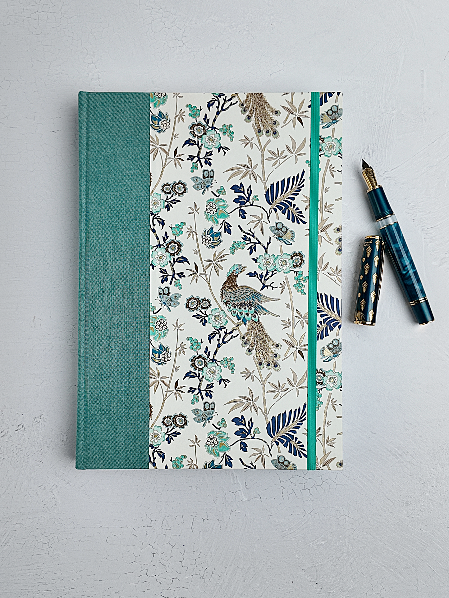 B5 192-page Hardcover Journal finished in Light Blue Verona book cloth and Peacock themed Florentine Print