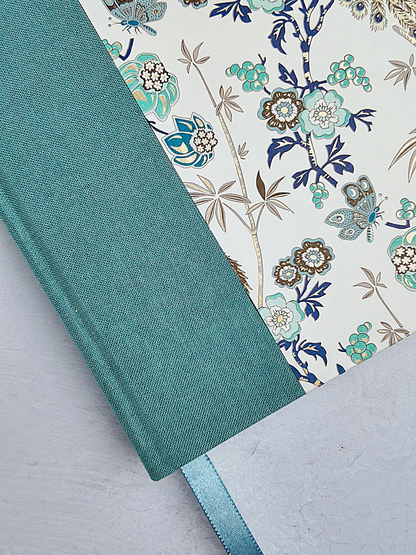 B5 192-page Hardcover Journal finished in Light Blue Verona book cloth and Peacock themed Florentine Print